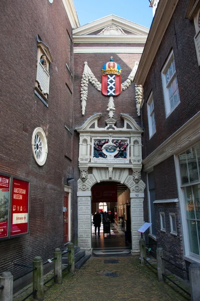 Entrance of the Amsterdam Museum with the coat of arms of Amsterdam.