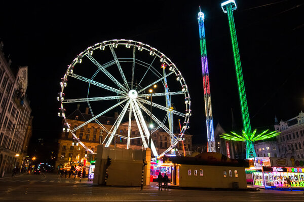 AMSTERDAM-APRIL 27: Dam Square and Royal Palace on the background at night during King 's Day on April 27, 2015 in Amsterdam, Netherlands
.