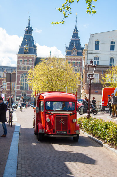 AMSTERDAM-APRIL 30: Citroen retro car on Amsterdam street, the Rijksmuseum is visible in the background on April 30, 2015, the Netherlands.