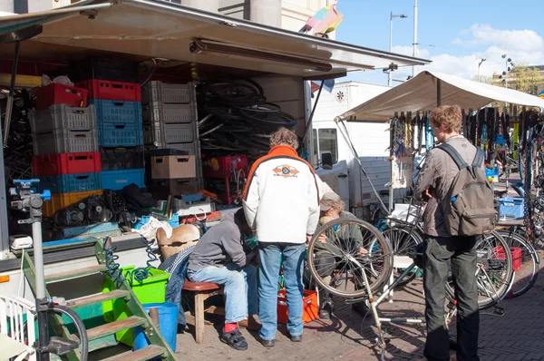 Vlooienmarkt op het Waterlooplein, kooplieden tonen hun curiosa en oude fietsen te koop, Nederland. — Stockfoto