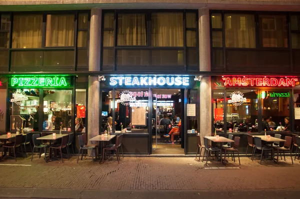 Amsterdam-May 01: Row of local steakhouse and restaurants in red-light district on May 01, 2015. — Stock Photo, Image
