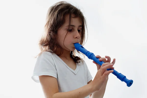 Happy girl playing the flute Stock Image