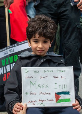 London, UK. 22nd May 2021. Young boy Pro-Palestine supporter with campaign sign at the London protest demonstration on Victoria Embankment, urging the UK government to take action to stop allowing Israel to act with impunity.