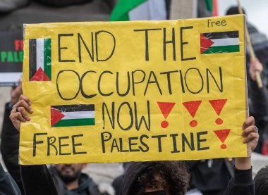 London, UK. 22nd May 2021. Pro-Palestine supporter with campaign sign at the London protest demonstration on Victoria Embankment, urging the UK government to take action to stop allowing Israel to act with impunity.
