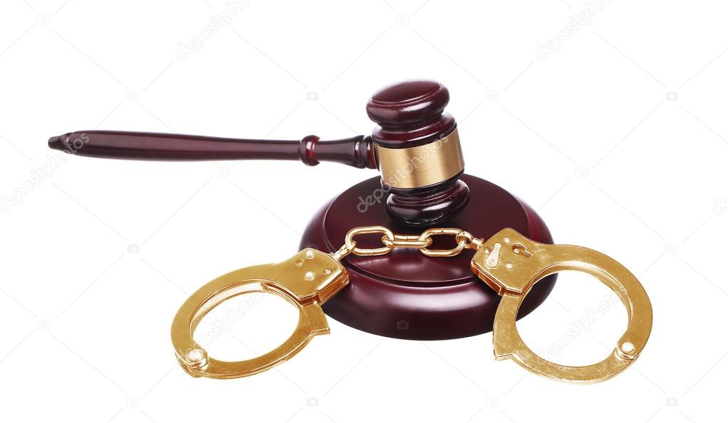 judge gavel and gold handcuffs with money isolated on white back