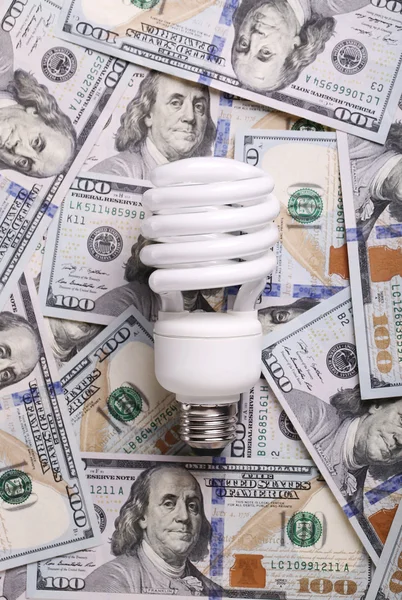 CFL Fluorescent Light Bulb on money dollar cash background — Stock Photo, Image