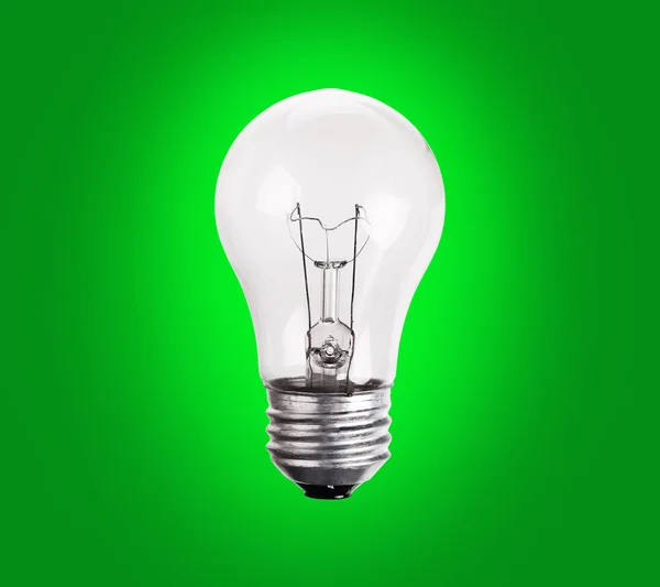 Old generation Light Bulb on green background — Stock Photo, Image