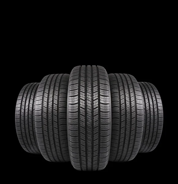 Five automobile rubber tires isolated on black background — Stock Photo, Image