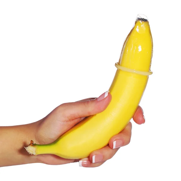 Μπανάνα με προφυλακτικό στο γυναικείο χέρι απομονωθεί σε φόντο. Contra — Φωτογραφία Αρχείου