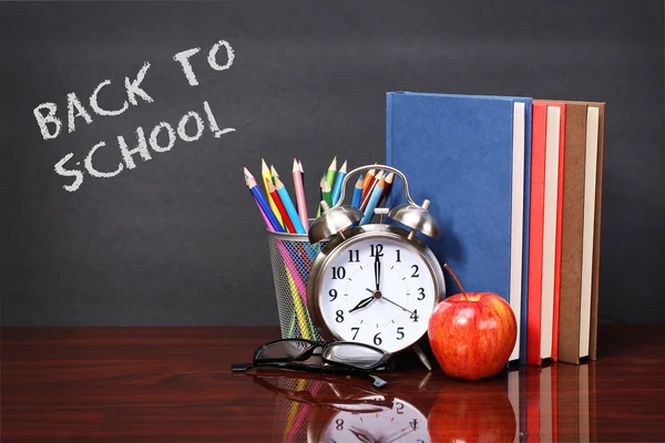 Books, apple, alarm clock and pencils on wood desk table. Text b — Stock Photo, Image