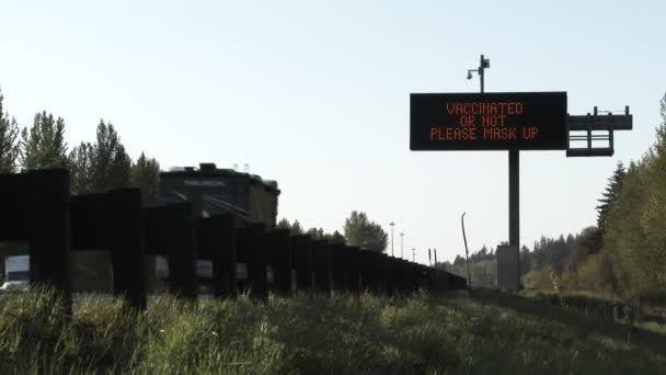 Road Sign Reads Vaccinated Please Mask Informing Drivers Passing — Stock Video