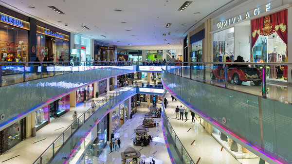DUBAI, UAE - MARCH 28, 2014: People walking inside Dubai Mall. At over 12 million sq ft, it is the world's largest shopping mall.