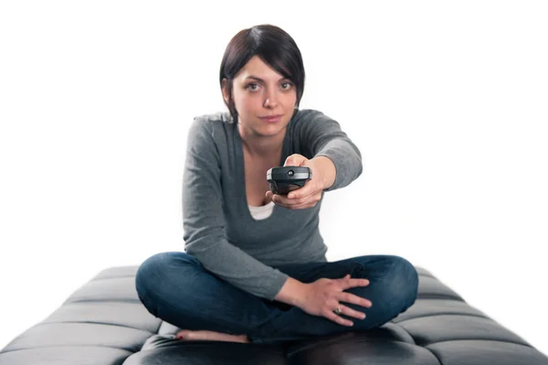 Woman pointing remote control. — Stock Photo, Image