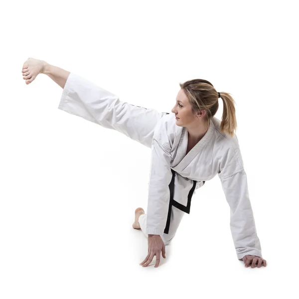 Blonde martial arts girl in kimono exercising karate. — Stock Photo, Image