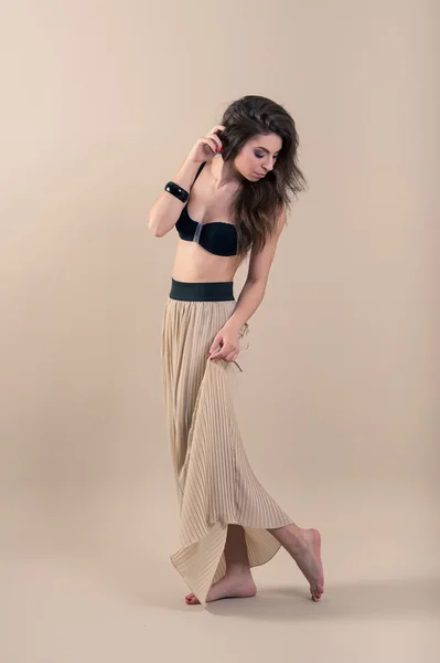 Sexy woman wearing bra and long skirt — Stock Photo, Image