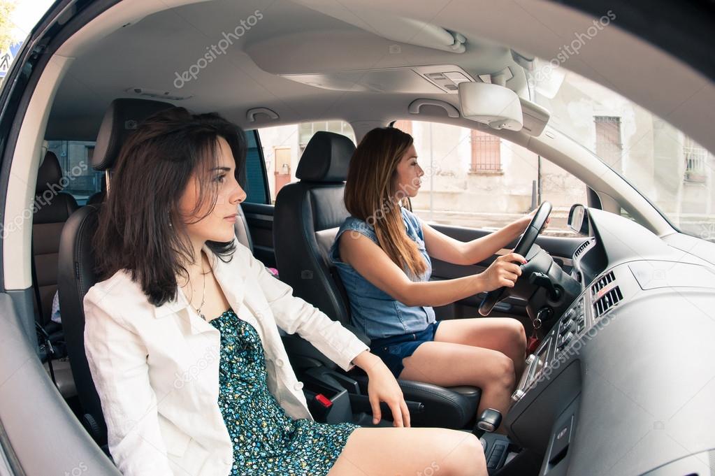 Two young female friends in a car