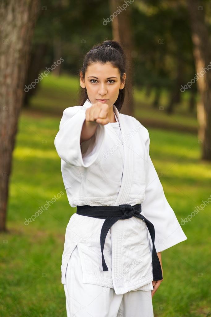 Young caucasian woman practicing judo