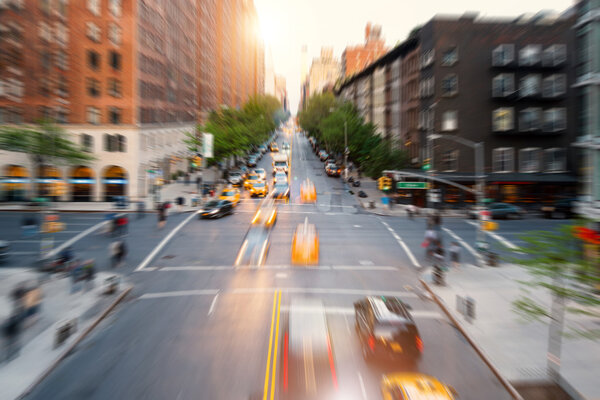 Street aerial view of midtown Manhattan with blurred moving cars. New York City. Radial zoom defocused editing. Rush lifestyle concept.