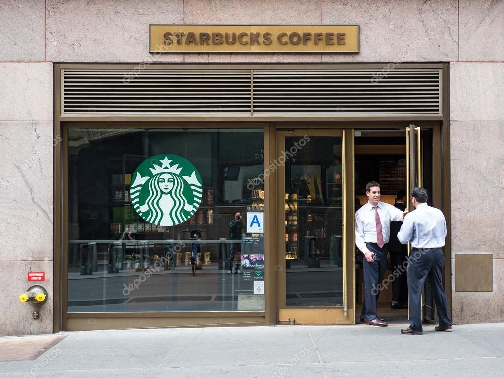 NEW YORK CITY, MAY 2015. People in front of Starbucks store close to Grand Central Station. Starbucks is the largest coffeehouse company in the world.