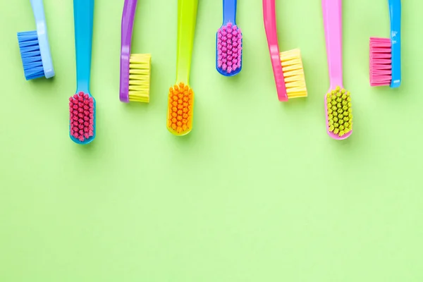 New Toothbrushes Set Green Paper Background Copy Space Top View — Stock Photo, Image