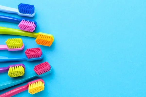 Colorful Toothbrushes Blue Paper Background Copy Space Top View — Stock Photo, Image