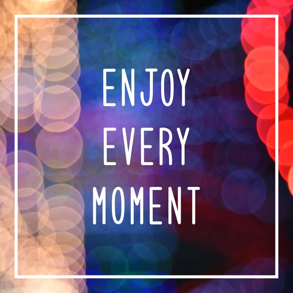 Enjoy every moment text on bokeh lights background — Stock Photo, Image