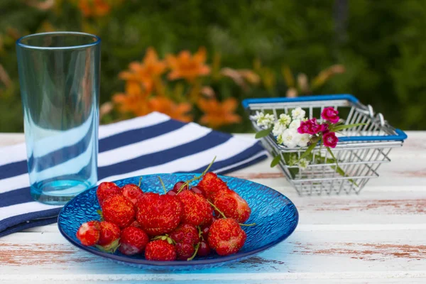 strawberries and currants on a plate. A healthy and healthy breakfast in nature.