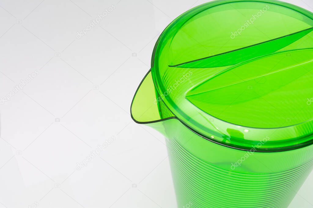 Green plastic jug close up isolated on white background. Copy space.