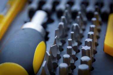 Tornavida hazır. Tornavida kutuları için metal parçalar. Ev kullanımı için bir takım aletler. Tornavida parçaları ve adaptörler. Büyücü başı farklı boyutlarda.