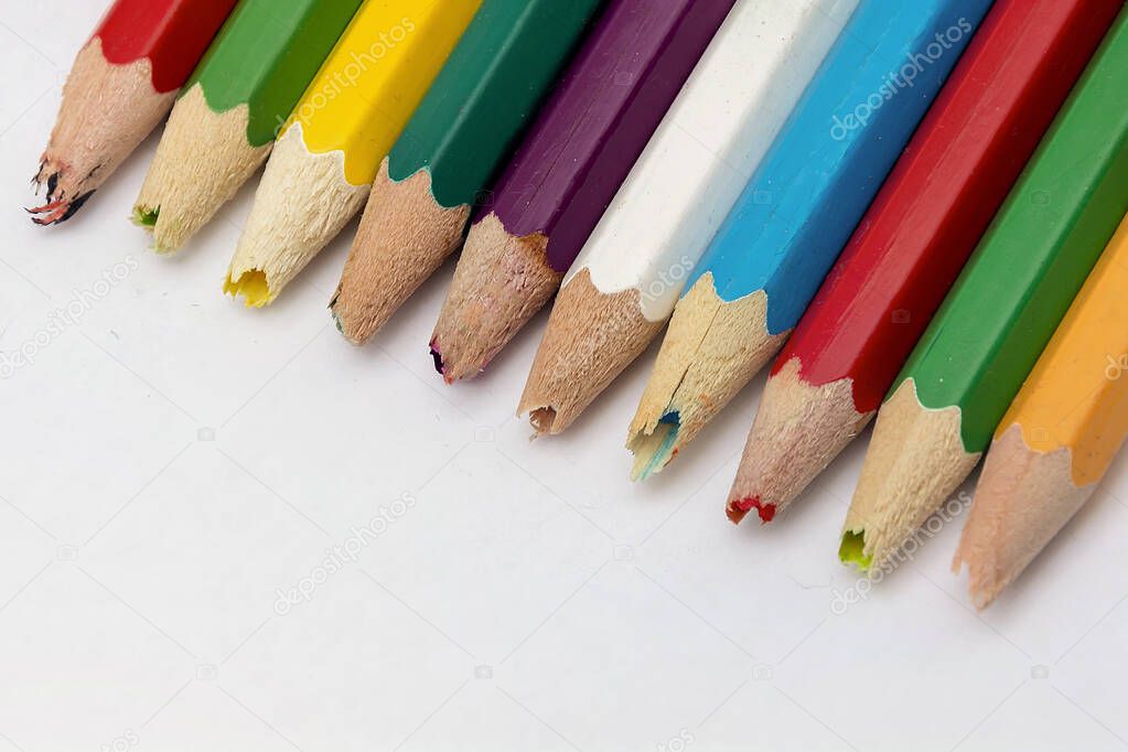 Set of old used and broken colored pencils on a white background. Ugly worn crayons or pencils with broken ends should be sharpened. Creativity, broken things or kids concept.