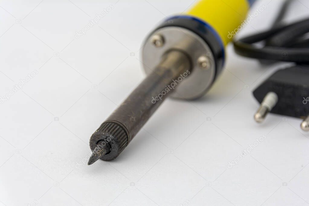 Soldering iron, on a white background. Soldering iron close-up. Electrical equipment repair concept.