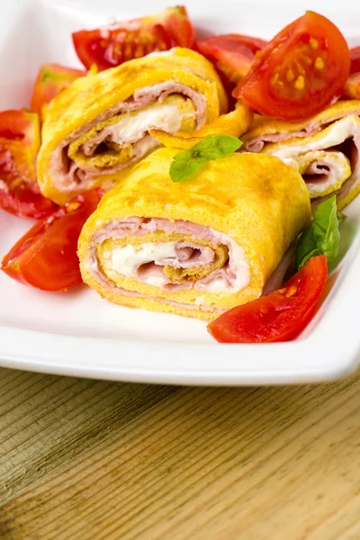 Delicious rolls omelette with tomato, ham and cheese cream — Stock Photo, Image