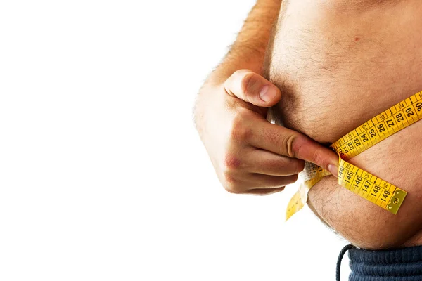 Big man measuring his belly with a measuring tape — Stock Photo, Image