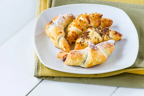 Mixed croissants in white plate — Stock Photo, Image