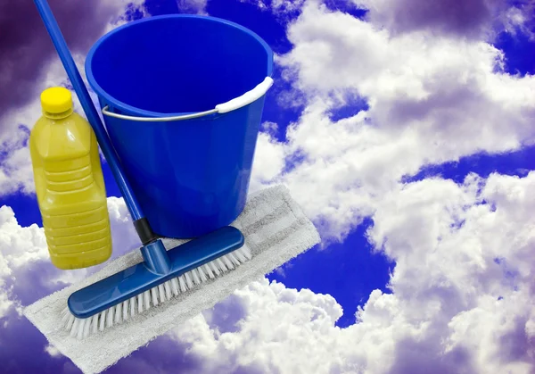 Bucket and mop over a blue cloudy sky — Stock Photo, Image