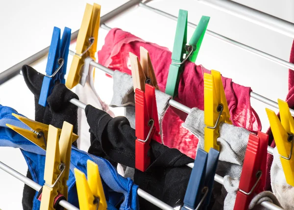 Mixed  clean laundry pinned with colourful clothespins — Stock Photo, Image