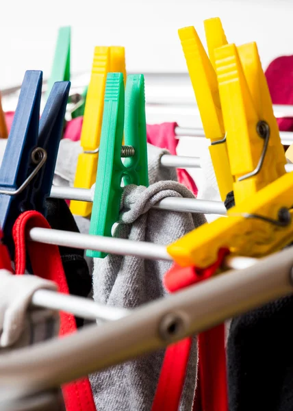 Mixed  clean laundry pinned with colourful clothespins — Stock Photo, Image