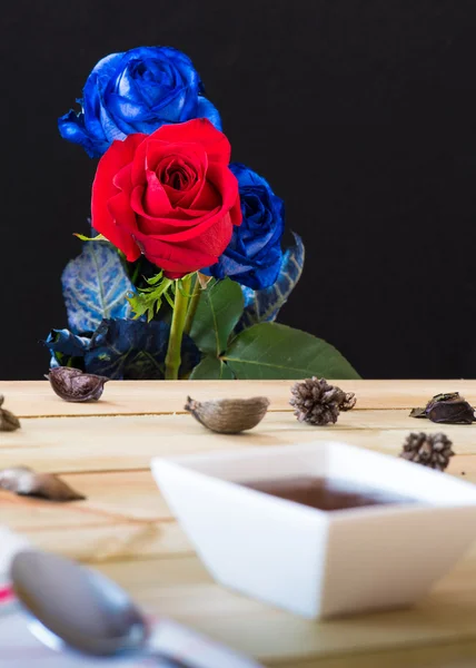 Шоколадний пудинг з полуницею та фоном троянд Ліцензійні Стокові Зображення