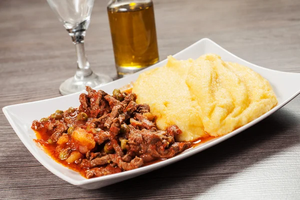 Traditional polenta with lamb stew — Stock Photo, Image