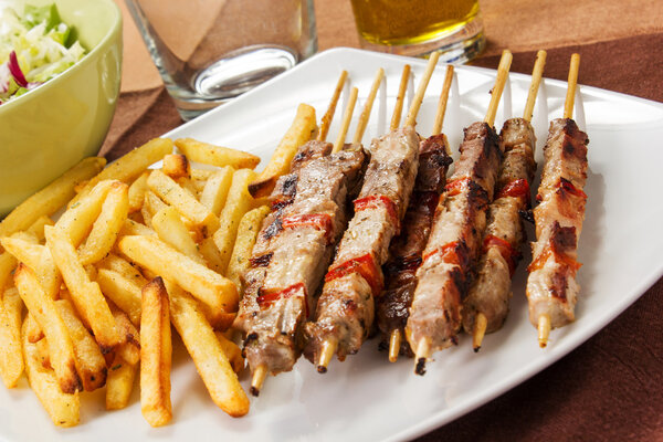 Pork skewers with french fries 