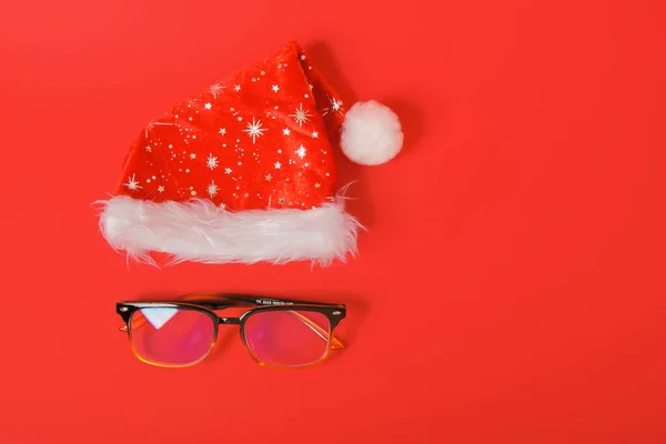 眼镜和红色背景的圣诞圣诞圣诞礼帽 — 图库照片