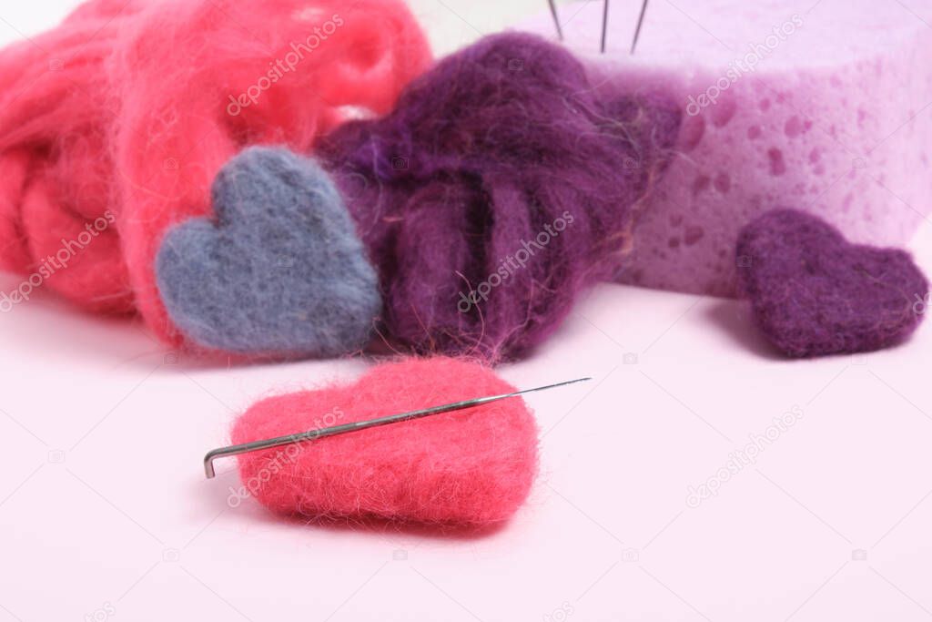 several multi-colored felted woolen hearts, romantic DIY decor, copy space close up