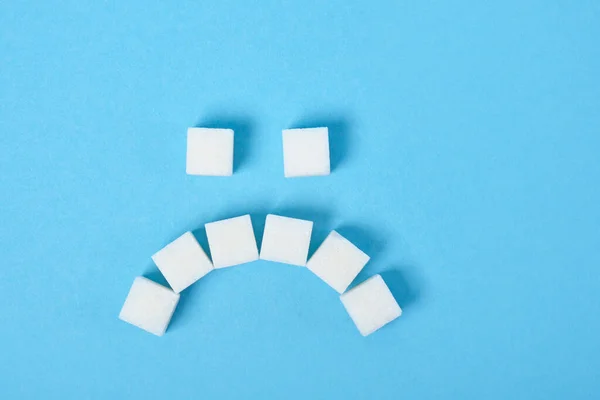 White Sugar Cubes Laid Out Form Sad Smile Blue Background — Stock Photo, Image