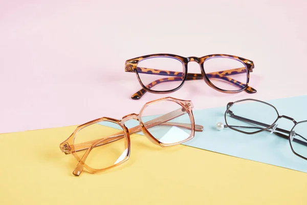 Multiple Eyeglasses Multicolored Background Pastel Colors Geometric Background Pink Yellow — Stock Photo, Image