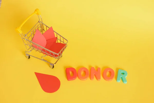 Paper Drops Blood Shopping Cart Inscription Donor Yellow Background World — Stok Foto