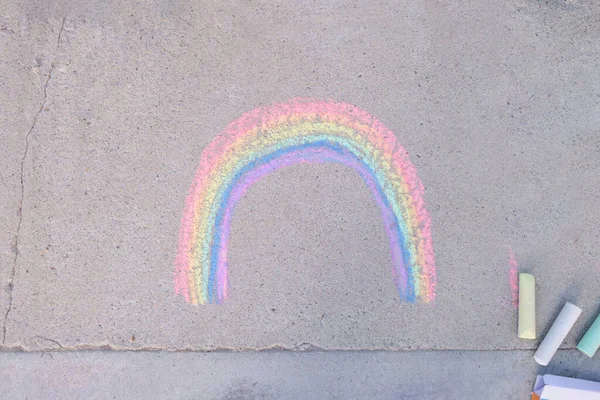 rainbow chalk drawn on the asphalt, symbol of the lgbt community, crayons on the ground top view
