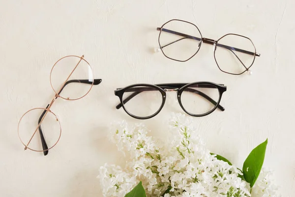 Several Different Trend Eye Glasses Branch White Lilac Textured Beige — Stock Photo, Image