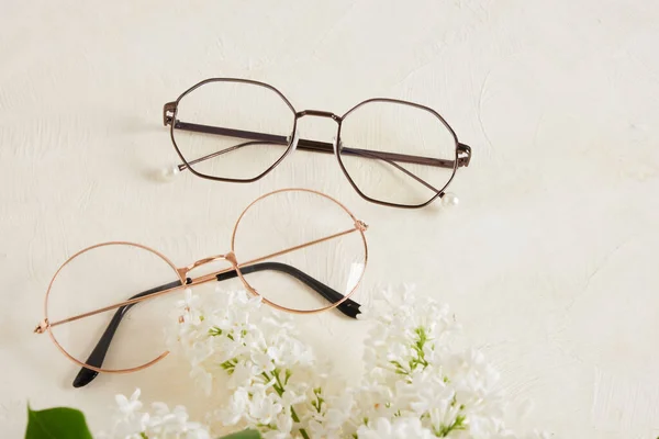 Several Different Trend Eye Glasses Branch White Lilac Textured Beige — Stock Photo, Image