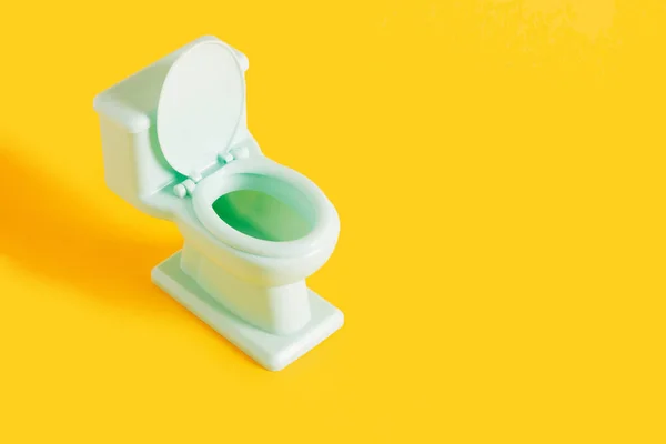 Green Toy Toilet Bowl Yellow Background Copy Space — Stock Photo, Image