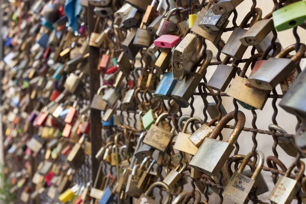 love padlocks affixed to a bridge